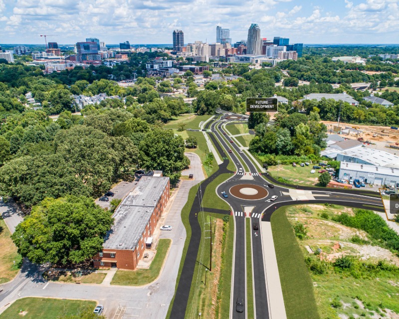Rendering of Lake Wheeler Road interchange showing roundabout and Raleigh skyline in background.