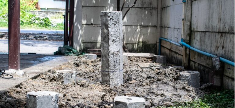 Hexagonal concrete micro piles installed in the ground for building foundation.