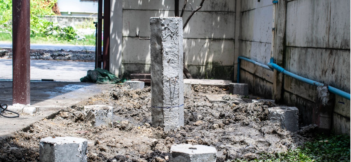 Hexagonal concrete micro piles installed in the ground for building foundation.