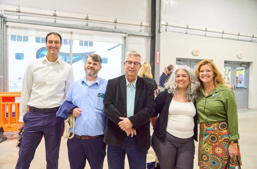 STV design team and partners posing indoors at Port of Philadelphia Cruise Terminal opening ceremony.