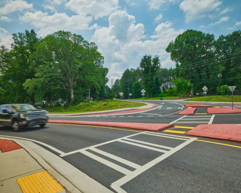 Car passing through roundabout interchange at Union and Butner roads in South Fulton, GA.