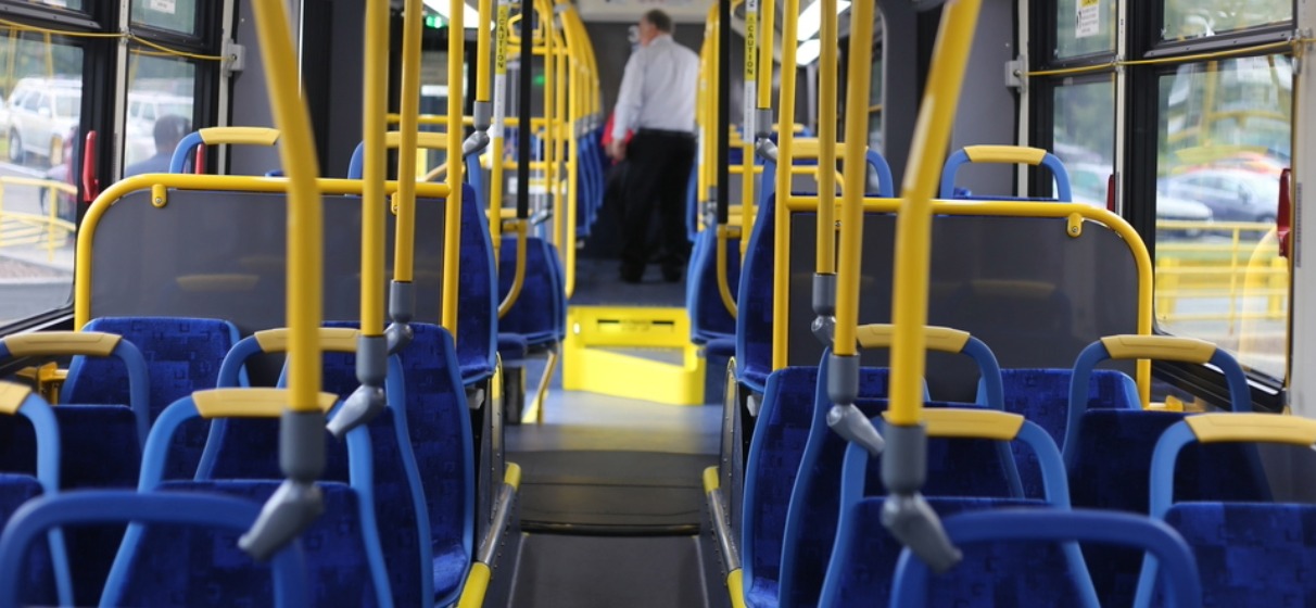 Interior of bus showing empty blue seats