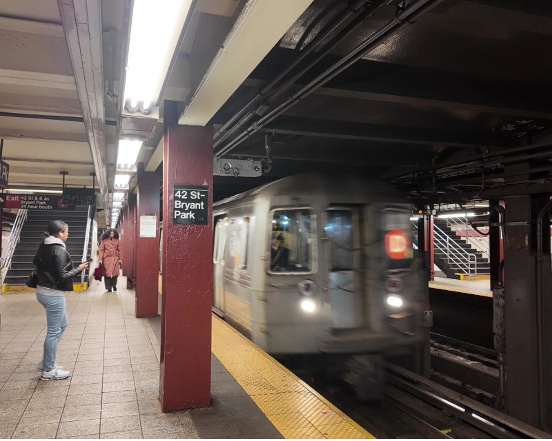 Passengers wait for D train at 42 St-Bryant Park Station in New York.