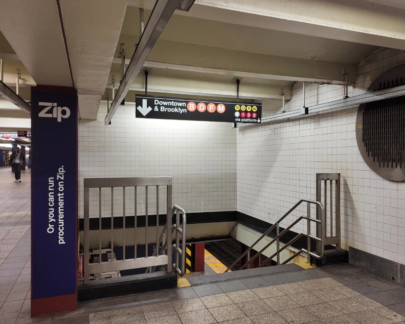 Staircase leading to subway platform at 42 St-Bryant Park Station in New York.