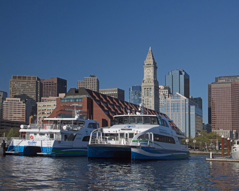 Two MBTA ferry vessels docked in Boston Harbor.