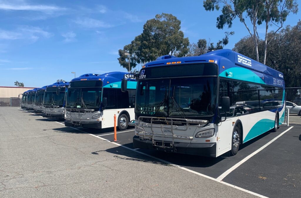 Multiple North County Transit District hydrogen-powered buses parked at a depot.